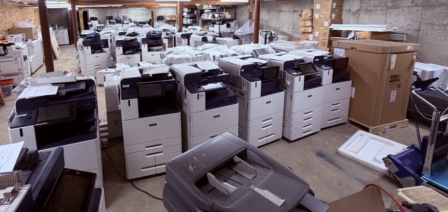 Rows of new Xerox AltaLink and VersaLink multifunction printers in the Advantage Business Systems warehouse in New Haven, Connecticut