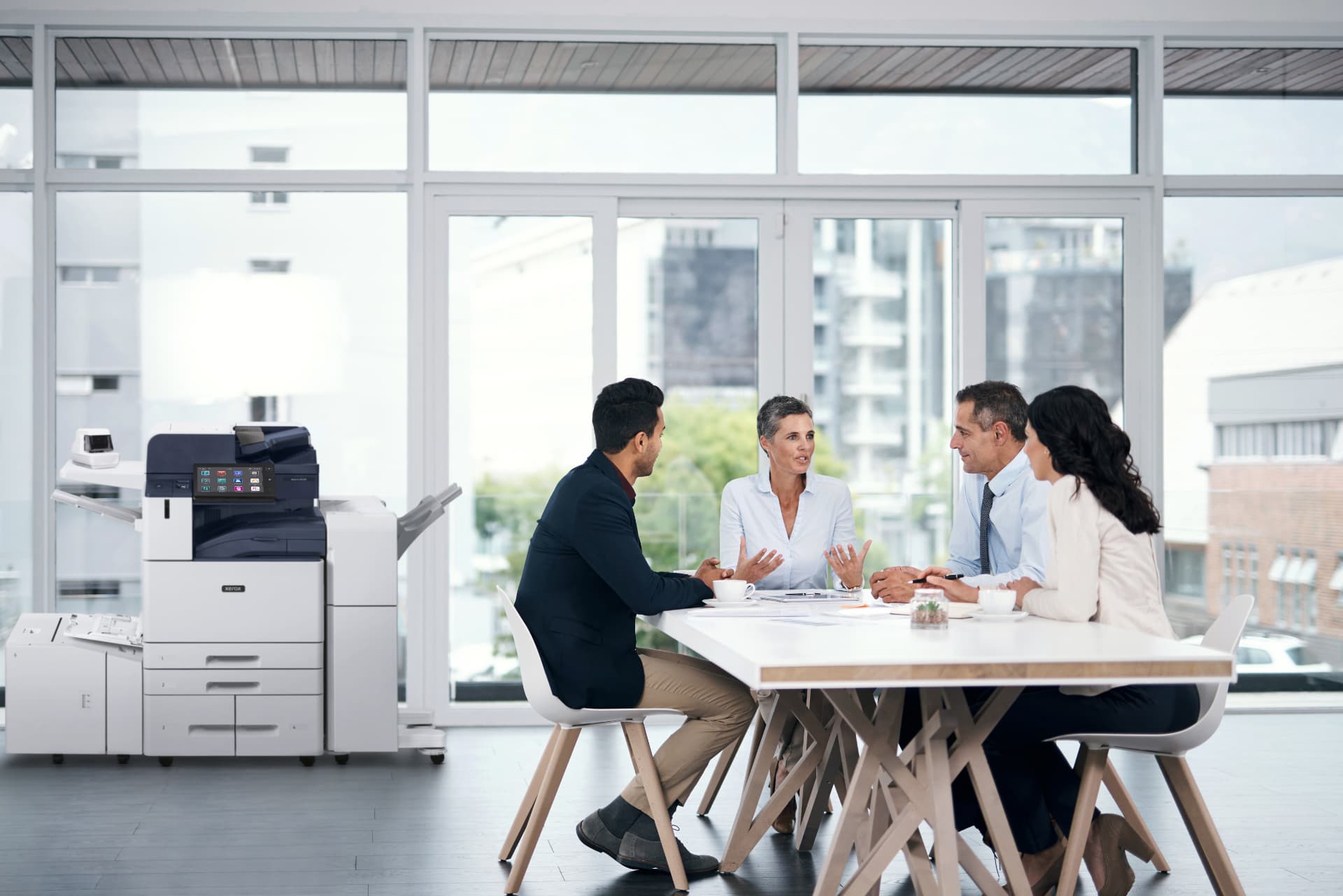 Leased Xerox AltaLink C8200 multifunction copier in a Connecticut office | Advantage Business Systems Xerox AltaLink C8200 multifunction printer beside a conference table during a team meeting in a modern office