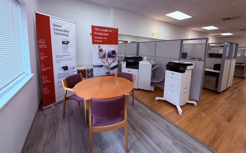 ABS Xerox showroom, New Haven CT — ConnectKey and production print display Advantage Business Systems showroom in New Haven, CT with Xerox ConnectKey and production print banners beside a customer meeting table